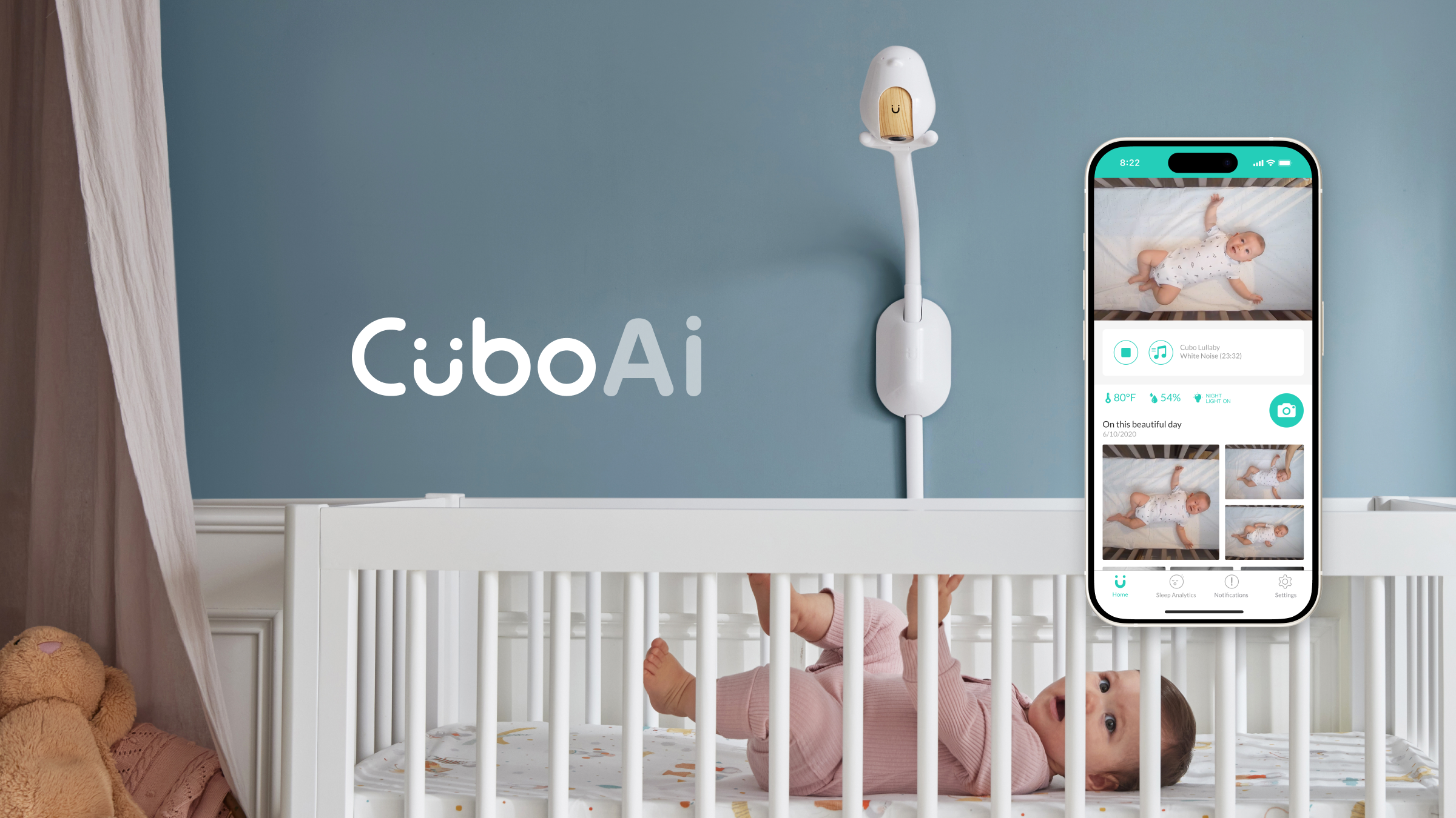 CuboAi baby monitor mounted above a crib beside the CuboAi mobile app